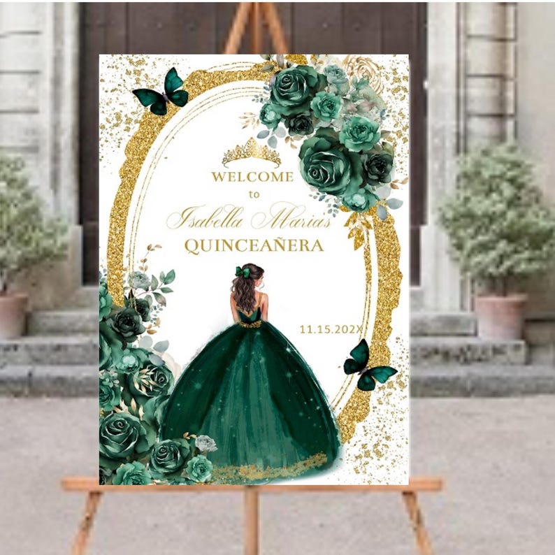 May include: A welcome sign for a Quincea&ntilde;era, featuring a gold glitter background with a green and gold floral design. The sign says "Welcome to Isabella Maria's Quincea&ntilde;era" and includes the date "11.15.202X".