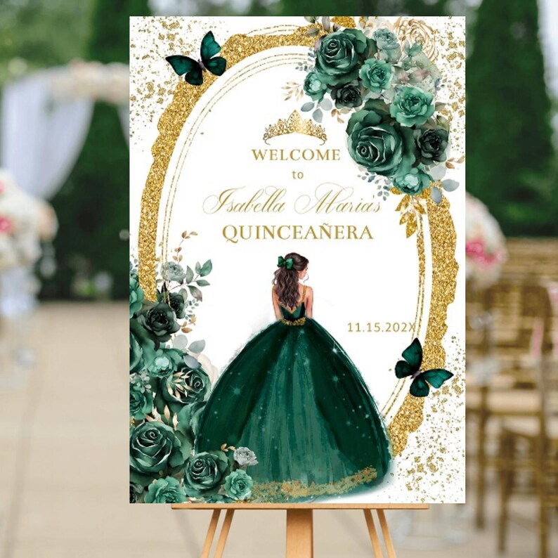 May include: Welcome to Isabella Maria's Quinceanera sign with a gold glitter background and a green floral design. A silhouette of a woman in a green gown is featured in the center of the sign. The date 11.15.2022 is printed in the bottom right corner.