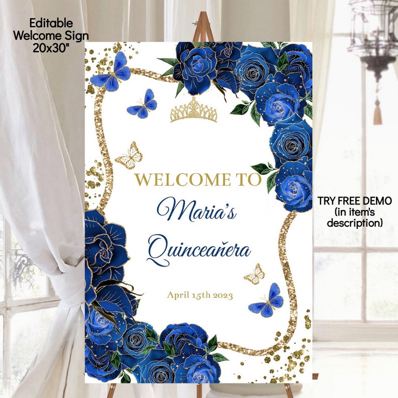 May include: A white welcome sign with gold glitter and blue flowers. The text on the sign reads "Welcome to Maria's Quincea&ntilde;era April 15th 2023".