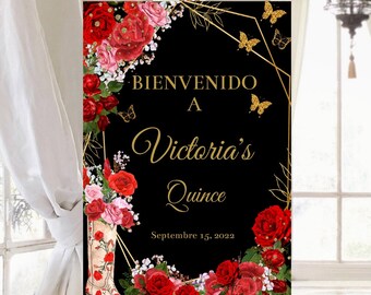 May include: Black welcome sign with gold lettering and floral accents. The sign reads "Bienvenido a Victoria's Quince Septiembre 15, 2022".