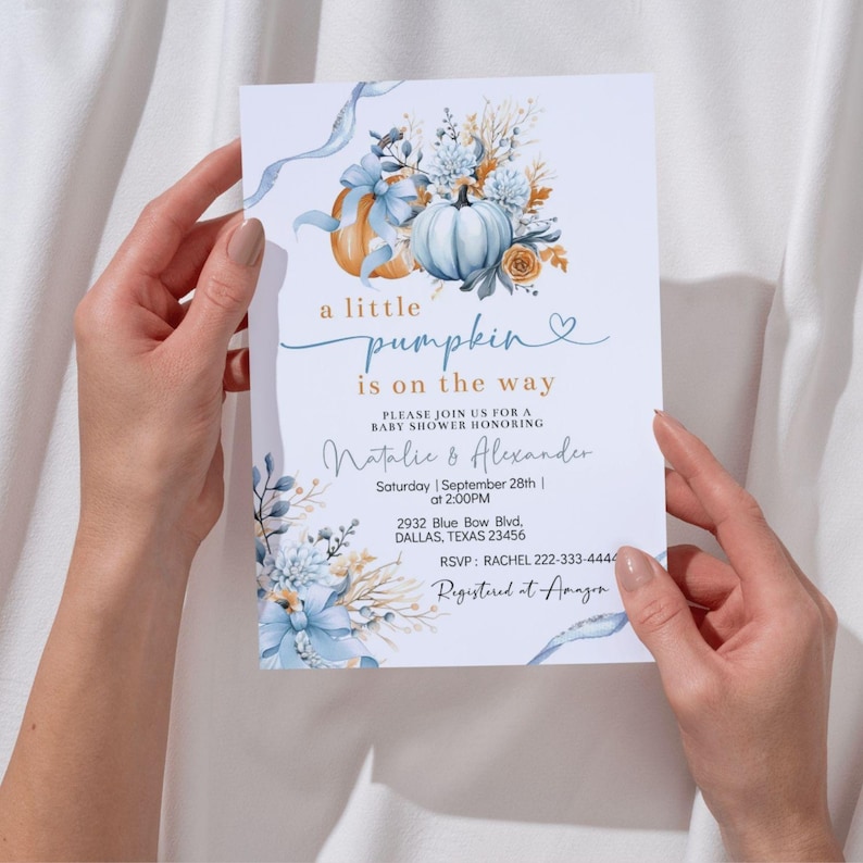 May include: Baby shower invitation featuring a watercolor design with pumpkins and floral elements in shades of blue, orange, and white. The text reads "a little pumpkin is on the way" with event details.
