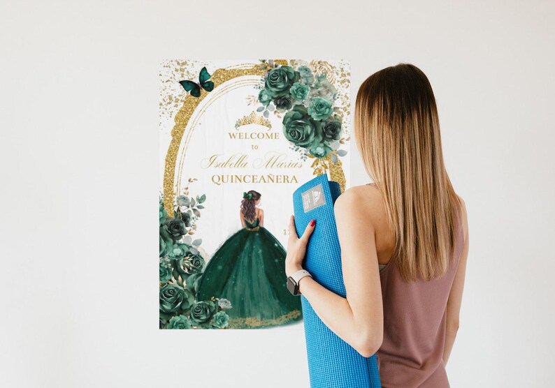 May include: A green and gold Quincea&ntilde;era welcome sign with a floral design and a butterfly. The sign says "Welcome to Isabella Maria's Quincea&ntilde;era".