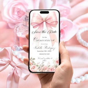 May include: A smartphone displays a pink invitation for a Quinceañera, featuring a large bow, floral accents, and the text "Save the Date." The background includes pink roses, pearls, and a perfume bottle, creating a soft, feminine aesthetic.