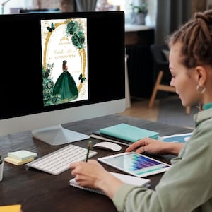 May include: A computer screen displaying a digital invitation with a green and gold design. The invitation features a woman in a green gown with a butterfly on her shoulder. The text on the invitation reads "Welcome to the Quincea&ntilde;era".