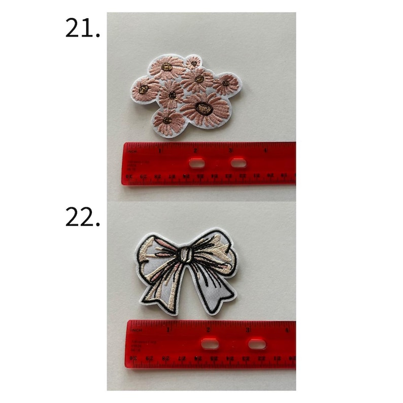 May include: Two embroidered patches: one of a cluster of pink flowers, the other of a white and gold bow. A red ruler is placed next to each patch. The flower patch measures approximately 2 inches in length. The bow patch measures approximately 2.5 inches in length.