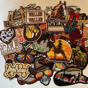 May include: A collection of embroidered patches with a Western theme. Designs include horses, cowboy hats, cacti, horseshoes, and the words "Y'all", "Wallen", and "Yeehaw". The patches feature various colors and intricate details.
