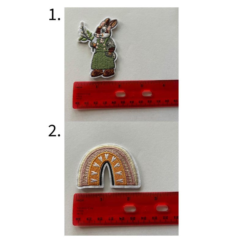 May include: Two embroidered patches: a rabbit wearing a green outfit and holding a sprig, and a rainbow with a sun design. The patches are placed next to a red ruler for size reference.