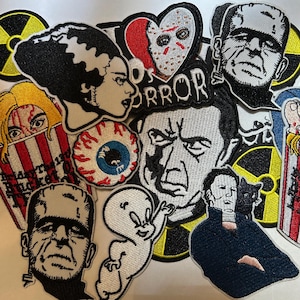 May include: A collection of embroidered patches featuring horror movie characters and symbols. Patches include Frankenstein's monster, the Bride of Frankenstein, Jason Voorhees, and Casper the Friendly Ghost. The patches are in various colors and shapes.