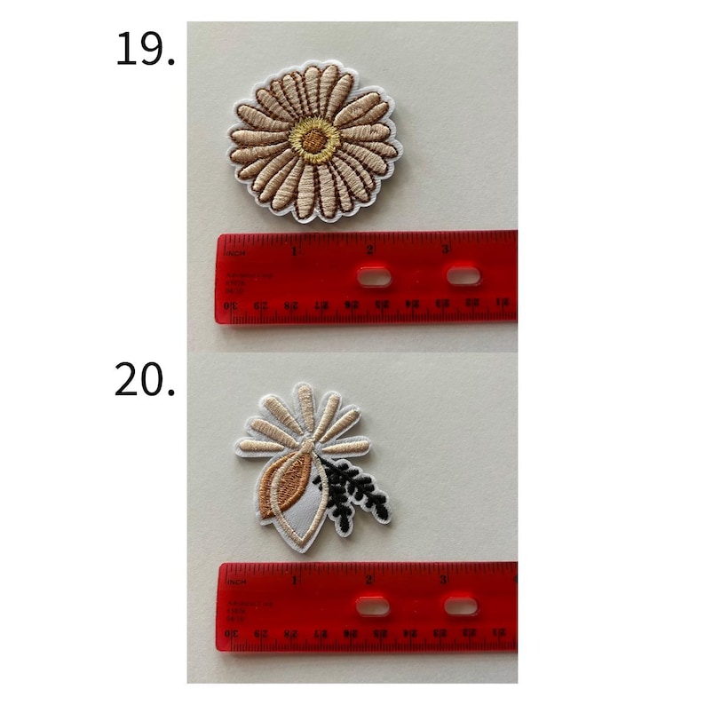 May include: Two embroidered patches. The first is a tan daisy with a yellow center, approximately 2 inches in diameter. The second is a tan, white, and black floral design, approximately 2 inches wide.