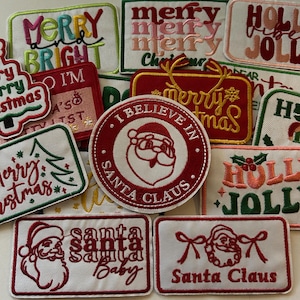 May include: A collection of Christmas-themed embroidered patches in various shapes. The patches feature festive phrases like "Merry Christmas," "Santa Claus," and "I Believe in Santa Claus." Colors include red, green, pink, and white.