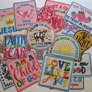 May include: A collection of embroidered patches with religious themes. The patches feature phrases like "Faith Over Fear," "Love Like Jesus," and "I Am a Child of God." Designs include a butterfly, strawberries, a bull, and a sunrise.