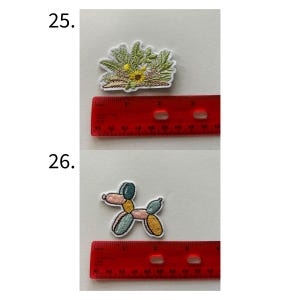 May include: Embroidered patches featuring a floral design with yellow and green hues, and a balloon dog in pastel colors. The patches are approximately 2 inches in length.