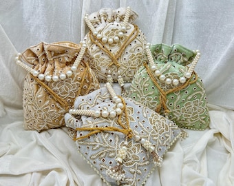 May include: Four embroidered drawstring bags with pearl embellishments. The bags are in shades of beige, green, and grey.