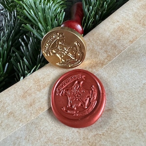 May include: Two wax seals featuring the Hogwarts crest. The seal on the left is gold and the seal on the right is red.