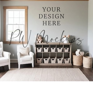 May include: A light-filled nursery or playroom setting with a neutral color palette. Features a wooden storage unit with woven baskets, two white armchairs, a rug, and decorative baskets. The text "YOUR DESIGN HERE" is displayed on the wall.