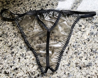 May include: Transparent black lace lingerie with a black elastic band.