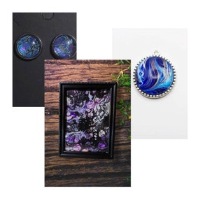 May include: A set of three handmade resin art pieces featuring swirling blue and purple abstract designs. The pieces are framed in black and silver and come in a variety of sizes, including earrings and a pendant.
