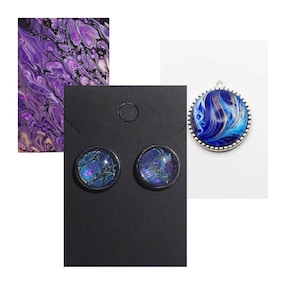 May include: A set of blue and purple abstract art earrings and a pendant necklace. The earrings are small and round, while the pendant is larger and has a silver border.
