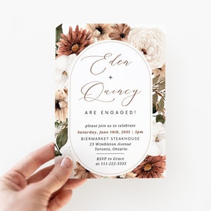 May include: A floral wedding invitation with a watercolor design featuring brown, white, and green flowers. The invitation announces the engagement of Eden and Quincy, with the date and location of the celebration: Saturday, June 18th, 2035 at 5pm at Biermarket Steakhouse, 23 Wimbleton Avenue, Toronto, Ontario. RSVP to Grace at 111-222-3333.