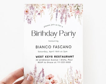 May include: A floral birthday party invitation with a white background and a border of watercolor flowers in shades of pink, purple, and green. The text reads "Please join us for a Birthday Party honoring Bianco Fascano Saturday, April 18th at 2pm West Keys Restaurant 23 Wimbleton Avenue | Aloha, Maui RSVP to Grace at 111-222-3333"