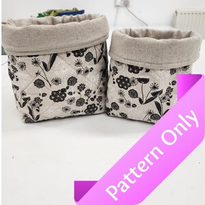 May include: Two beige fabric storage baskets with black and white floral patterns. The baskets are quilted and have a linen-like texture. The text "Pattern Only" is visible in the lower right corner of the image.