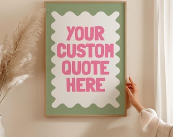 May include: A framed art print with the text "YOUR CUSTOM QUOTE HERE" in pink, set against a white, scalloped shape on a green background. The print is in a wooden frame.