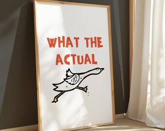 May include: A framed print with a white background and a red text overlay that says "WHAT THE ACTUAL". A cartoon goose is flying to the right with its wings spread out.