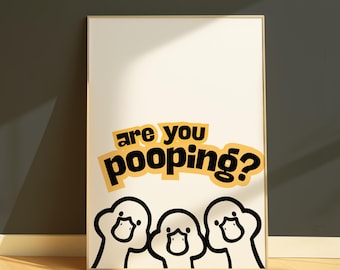 May include: Framed art print with the text "are you pooping?" in black and yellow. Below the text are three cartoon duck illustrations in black and white. The artwork is displayed on a wooden floor.