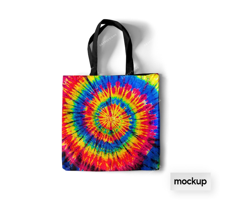 May include: A black tote bag with a colorful tie-dye pattern. The pattern features a large, swirling circle of red, yellow, blue, and green.