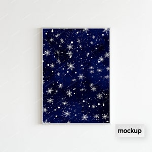 May include: A framed print with a dark blue background and a white snowflake pattern. The print is in a silver frame and is hanging on a white wall.
