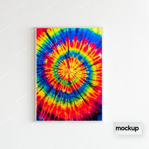 May include: A framed print of a colorful tie-dye pattern in shades of red, yellow, blue, and green. The pattern is a circular design with a white center.