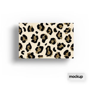 May include: A beige background with a repeating pattern of black leopard spots with gold glitter accents.