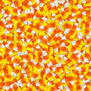 May include: A close-up image of a pile of candy corn. The candy corn is yellow, orange, and white.