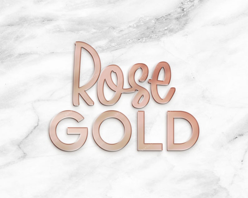 May include: Rose Gold text in a stylized font on a white marble background.