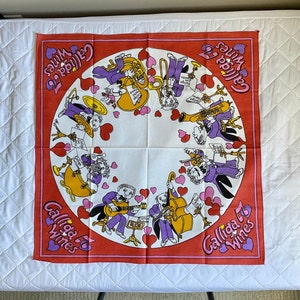 May include: A red and white square fabric with a circular design featuring musical instruments and people playing them. The text "Calliga '75 Wines" is repeated in the corners of the fabric.