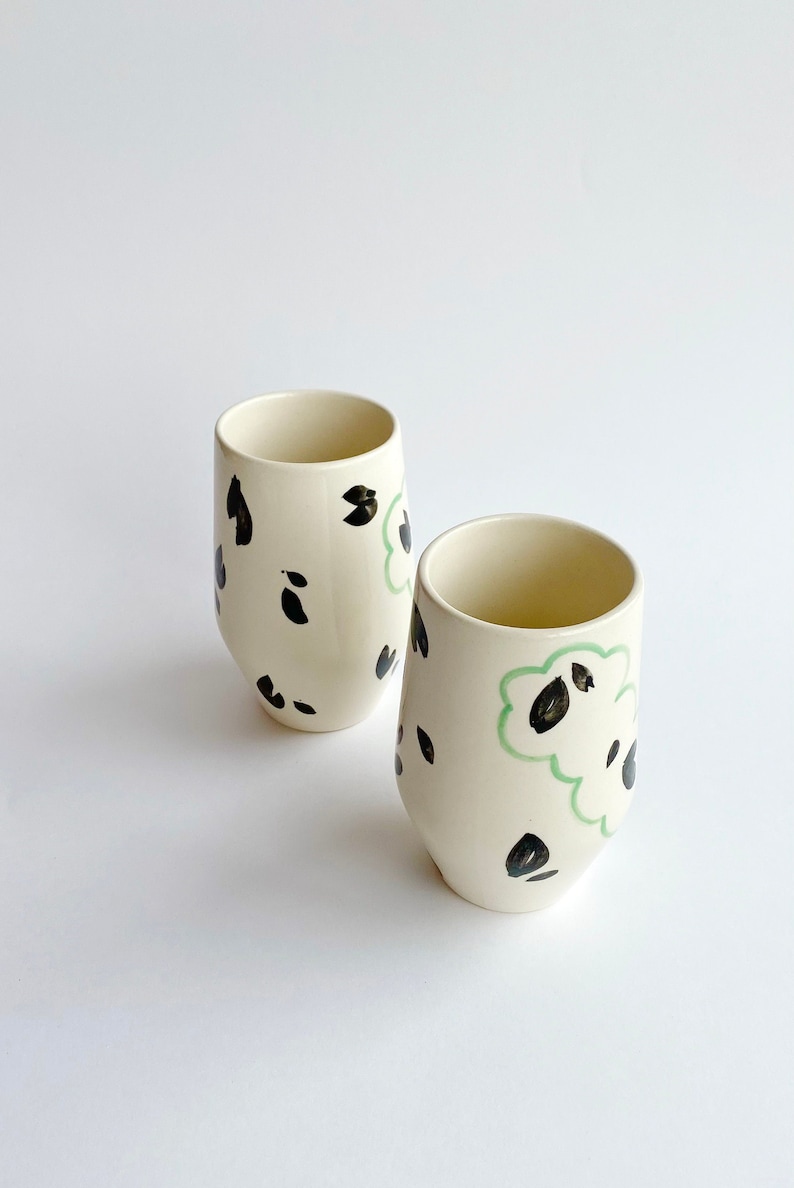 Handmade ceramic coffee or tea cup mug with unique design and round handle