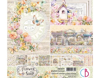 May include: A paper pad titled Flower Shop featuring 12 double-sided sheets with floral, butterfly, and vintage shop illustrations. The cover displays a clock face, a birdhouse, and storefronts in soft pastel colors with text including Flower Shop.