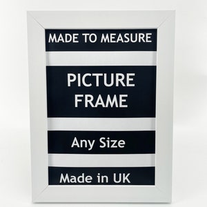 May include: White picture frame with black and white stripes and the text "MADE TO MEASURE PICTURE FRAME Any Size Made in UK"