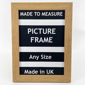 May include: A natural wood picture frame with black and white stripes and the text "MADE TO MEASURE PICTURE FRAME Any Size Made in UK".