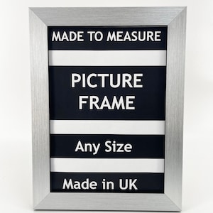May include: Silver picture frame with black and white stripes and the text "Made to Measure Picture Frame Any Size Made in UK".