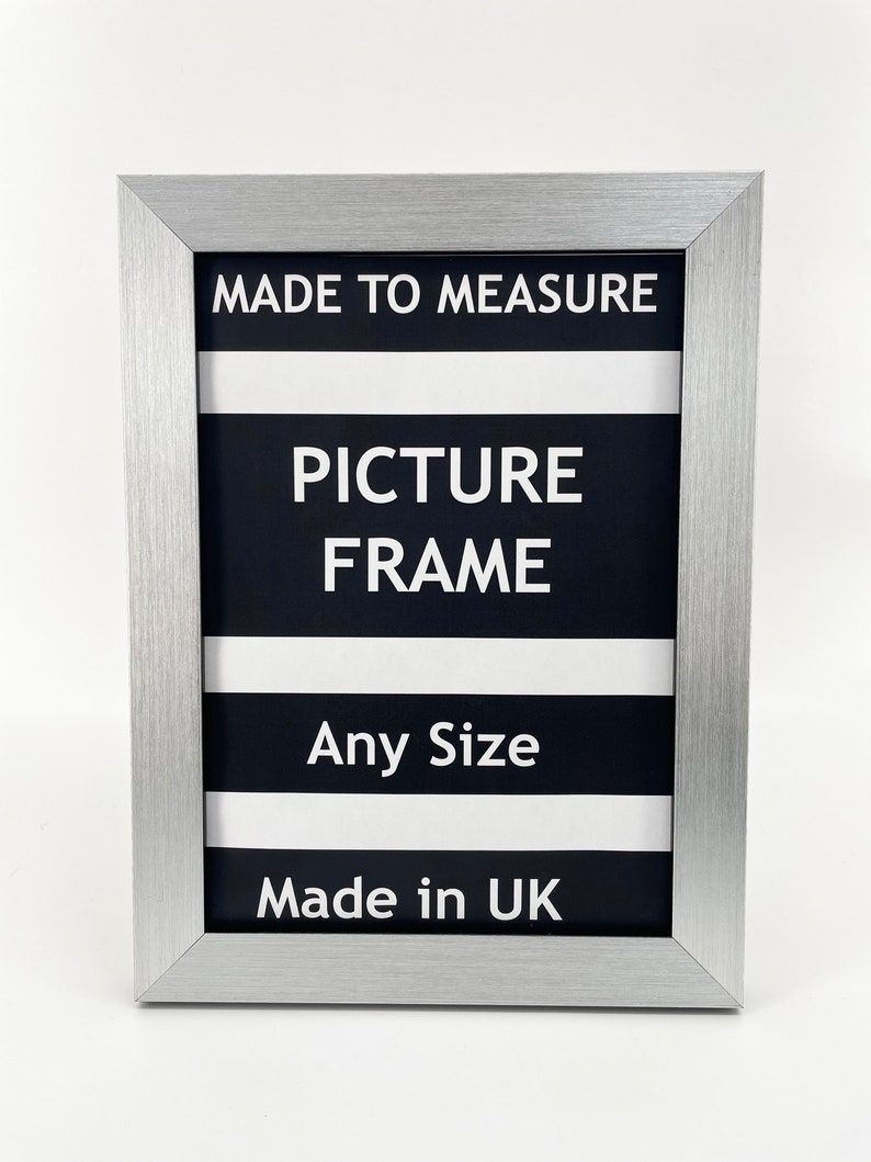 May include: Silver picture frame with black and white stripes and the text "Made to Measure Picture Frame Any Size Made in UK".
