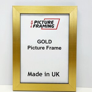May include: Gold picture frame with a white mat and the text "Kwik Picture Framing" and "Gold Picture Frame" and "Made in UK".