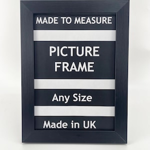May include: Black picture frame with white text that reads "Made to Measure Picture Frame Any Size Made in UK".