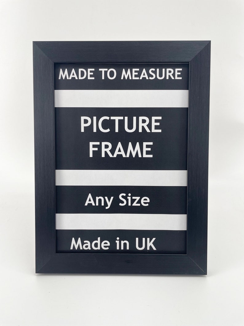 May include: Black picture frame with white text that reads "Made to Measure Picture Frame Any Size Made in UK".