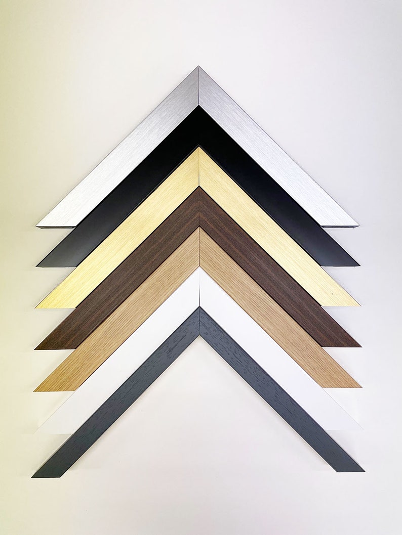 May include: A set of six picture frames with different colored frames. The frames are arranged in a pyramid shape, with the largest frame at the top and the smallest frame at the bottom. The frames are made of wood and metal, and they are all in different colors, including silver, black, gold, brown, white, and gray.
