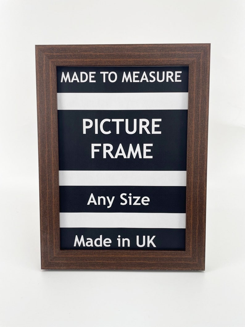 May include: A brown wood picture frame with white text that reads "Made to Measure Picture Frame Any Size Made in UK".