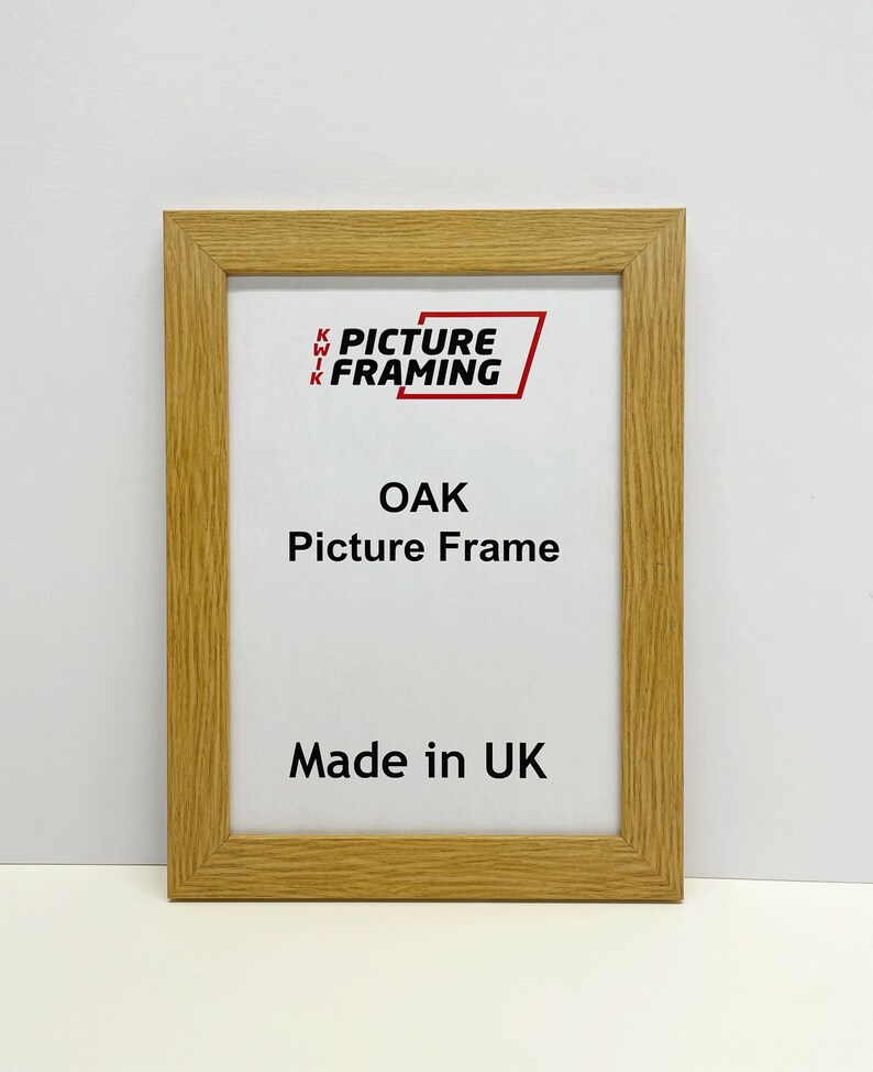 May include: A natural oak picture frame with the text "Kwik Picture Framing" and "Oak Picture Frame" in red. The frame also says "Made in UK".