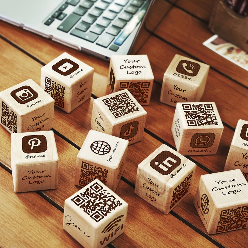 a group of wooden dices sitting on top of a wooden table