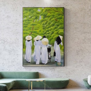 May include: A painting of four people wearing white ao dai dresses and traditional conical hats walking down a path lined with green trees.