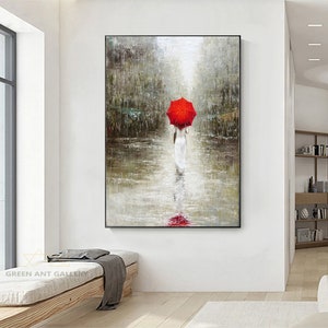 May include: A painting of a person walking in the rain with a red umbrella. The person is wearing a white dress and is walking away from the viewer. The background is a blurry cityscape.